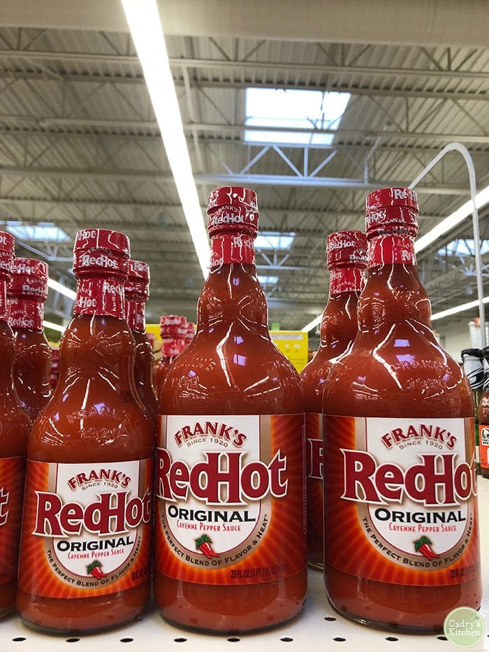 Frank's RedHot sauce on store shelf.