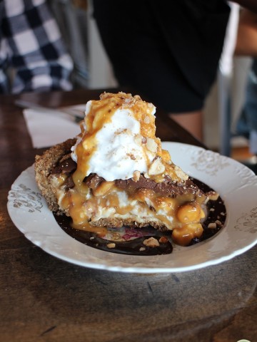 Slice of Snickers pie on plate at Modern Love Omaha.
