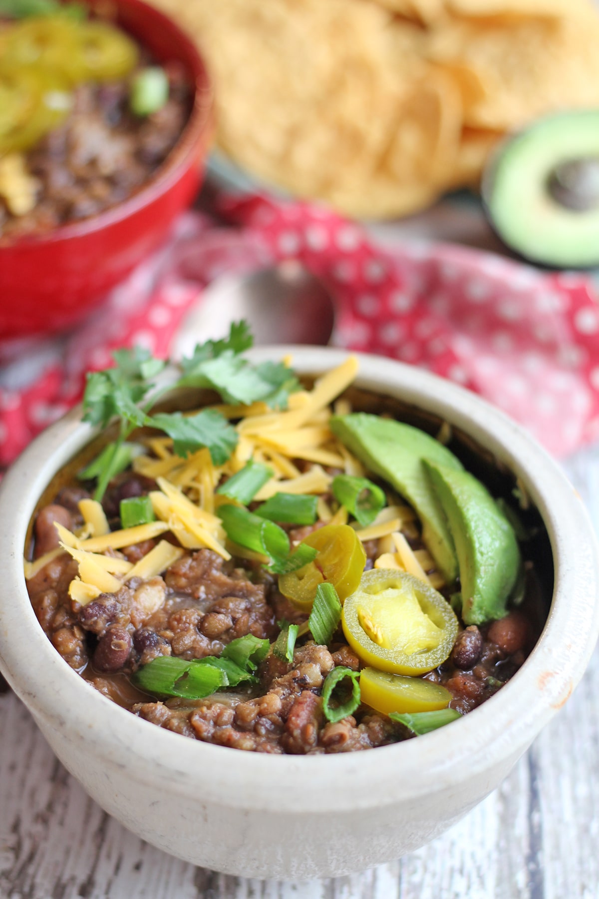 Avocado and vegan cheese on lentil chili.