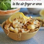 Text: Easy roasted cauliflower in the oven or air fryer. Vegan and gluten free. Roasted cauliflower in bowl with lemon slice.