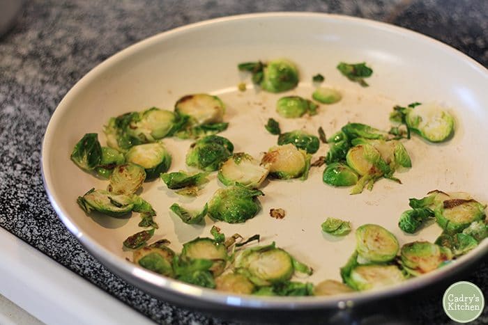 Browned Brussels sprouts in skillet.