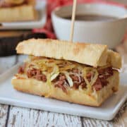 Vegan French dip sandwich with au jus, sauteed onions, and horseradish mayo on ciabatta baguette.