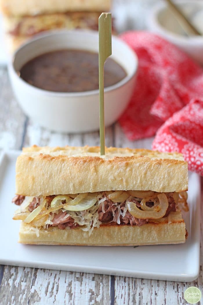 Vegan French dip sandwich with au jus for dipping.