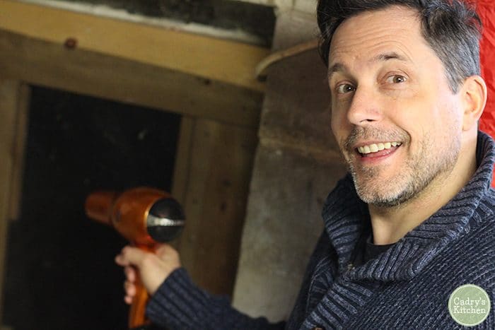 David blow drying frozen pipes in basement.