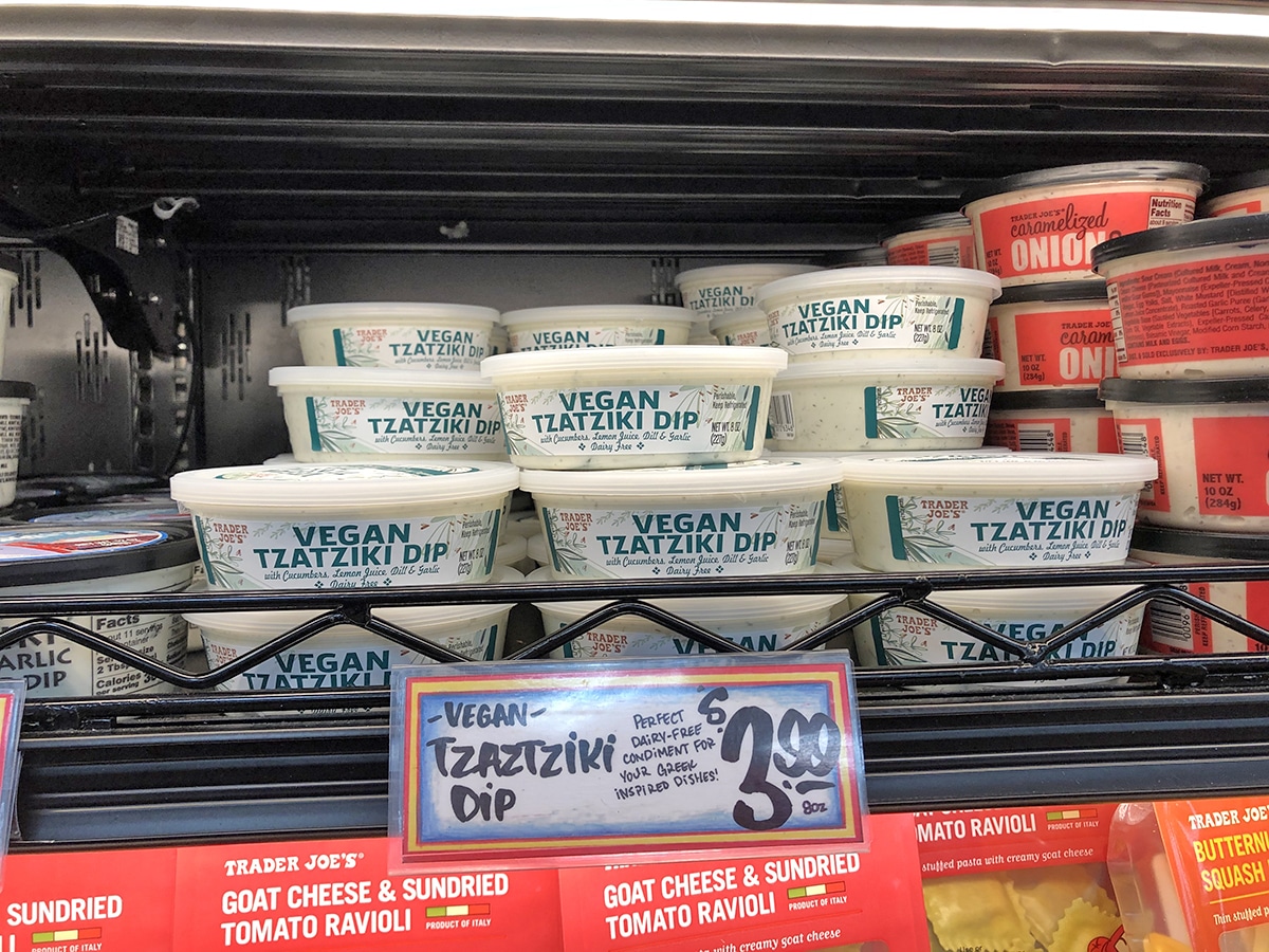 Containers of vegan tzatziki on the shelf.