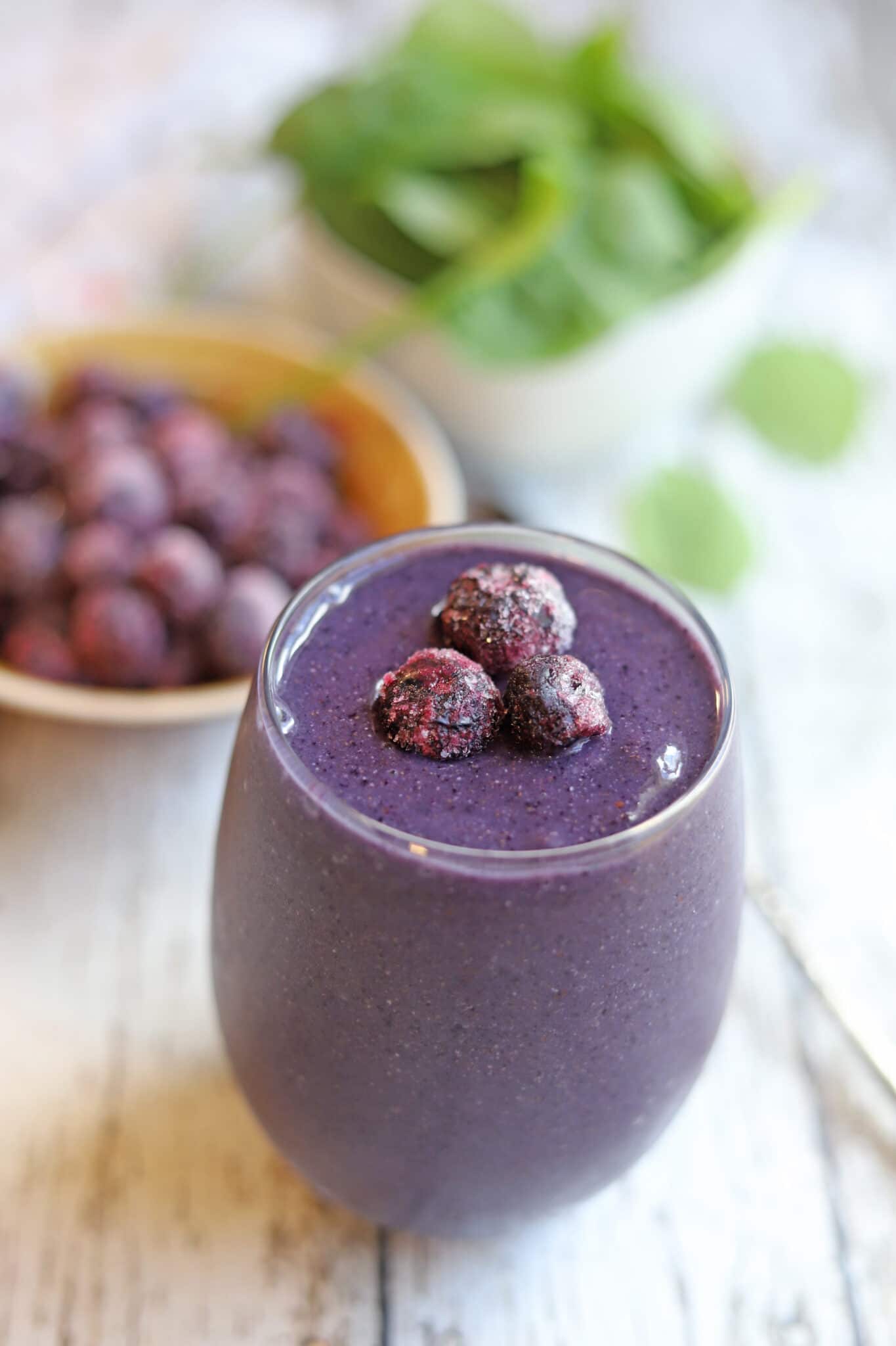 Frozen blueberries on top of a smoothie.
