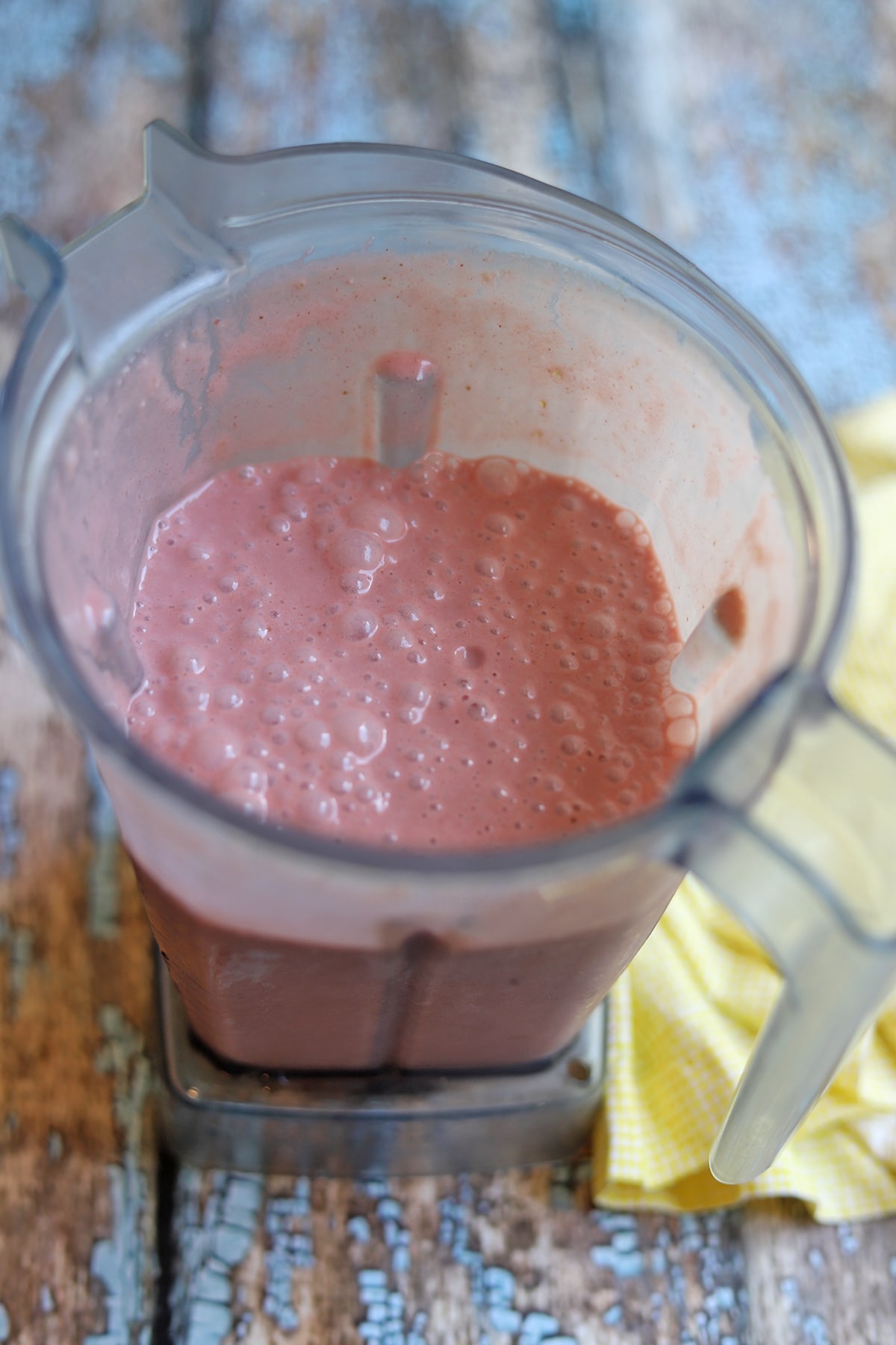 Blended strawberry milk in blender pitcher.