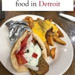 Text: Where to go for vegan food in Detroit. Gyro & chili cheese fries on plate.