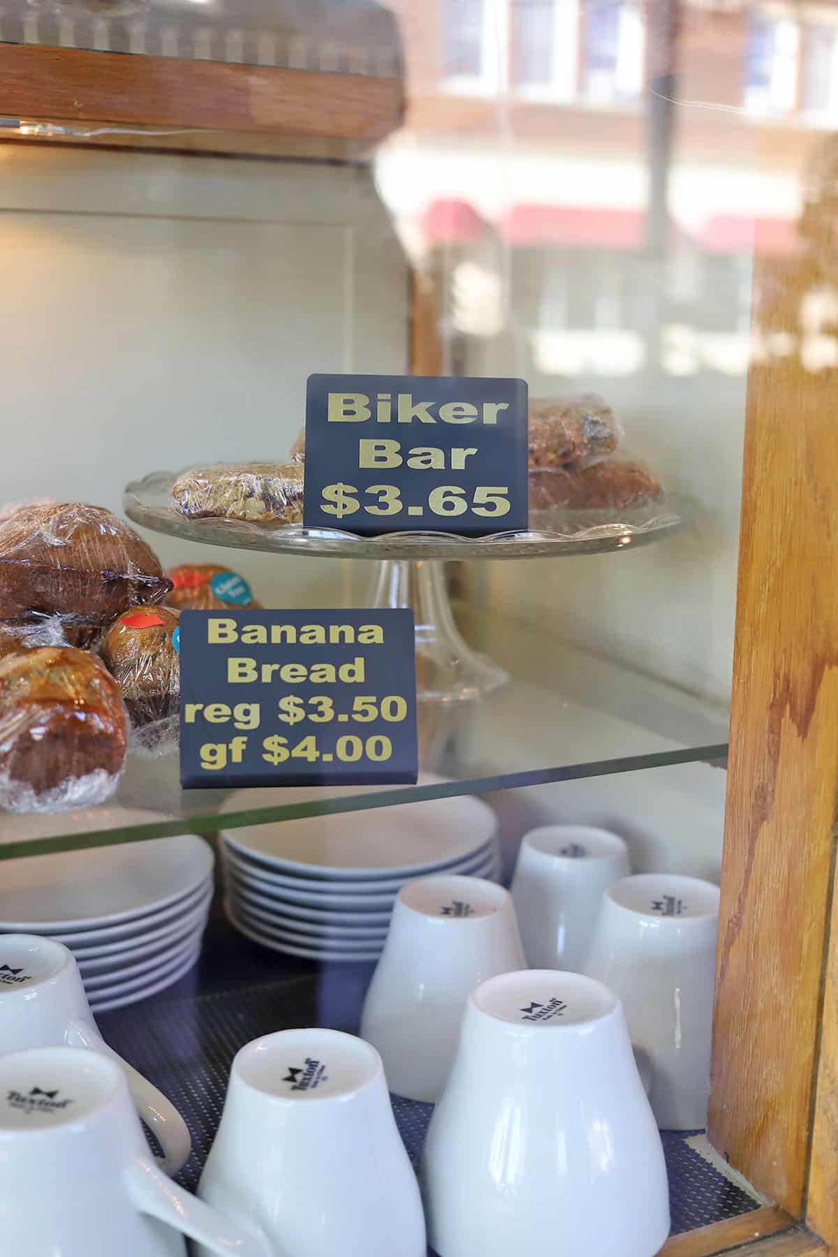 Pastry case with biker bars and banana bread.