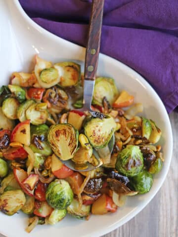 Platter with roasted Brussels sprouts, apples and caramelized onions.
