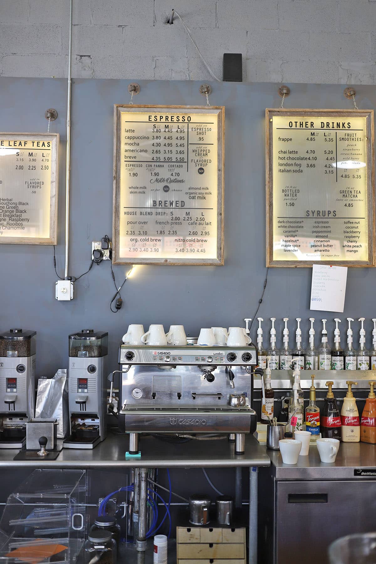 Wall menu and espresso machine.
