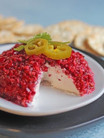 Mound of vegan cream cheese topped with cranberry salsa.