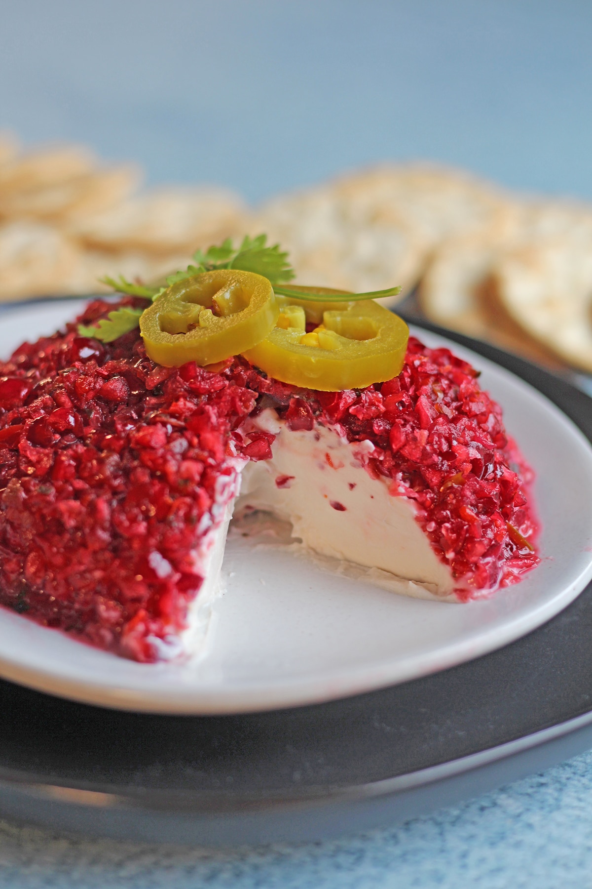 Mound of vegan cream cheese topped with cranberry salsa.