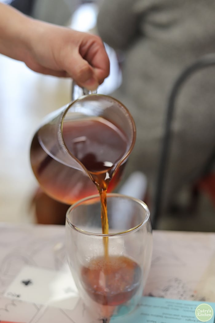 Tea being poured into a glass.