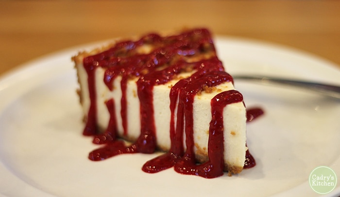 Vegan cheesecake with raspberry drizzle.