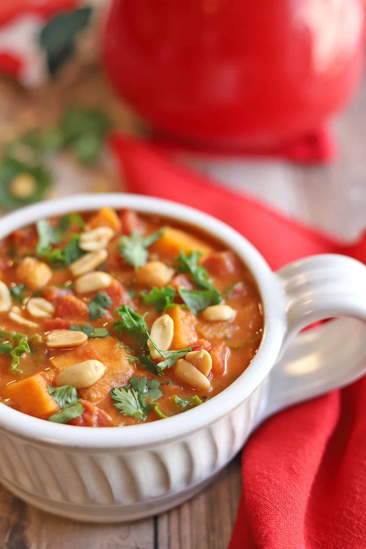 Close-up sweet potato peanut stew by red napkin.