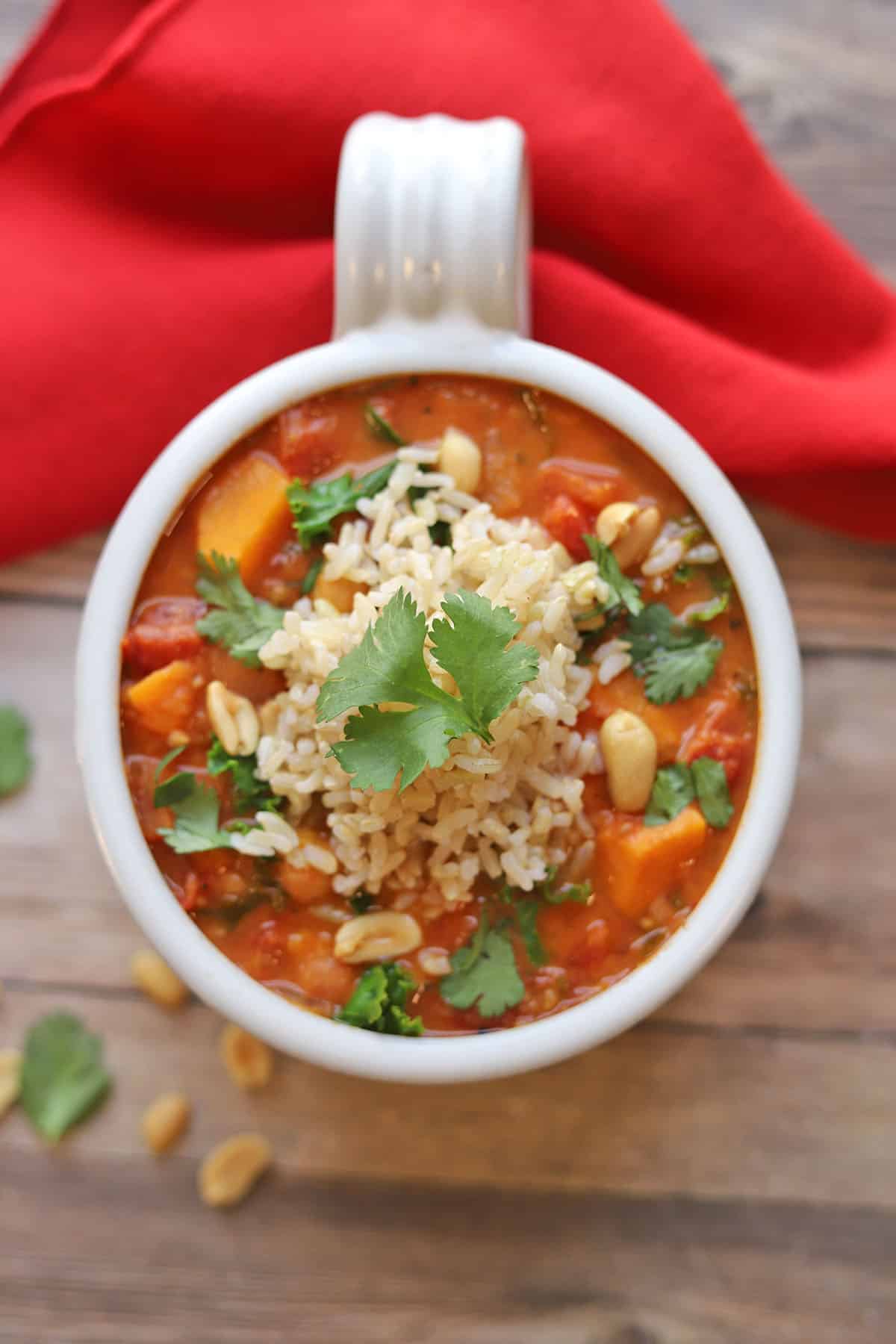 Overhead dollop of rice on sweet potato peanut stew.