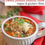 Text overlay: Sweet potato peanut stew pin. Bowl of stew on table by napkin.