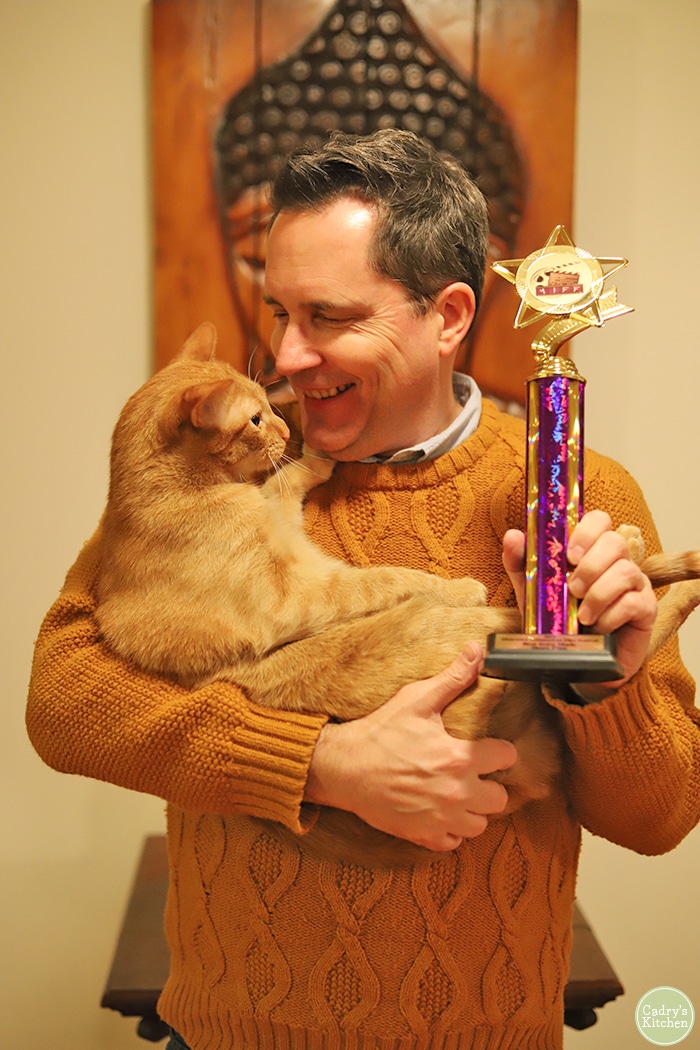 David holding Avon and a trophy.
