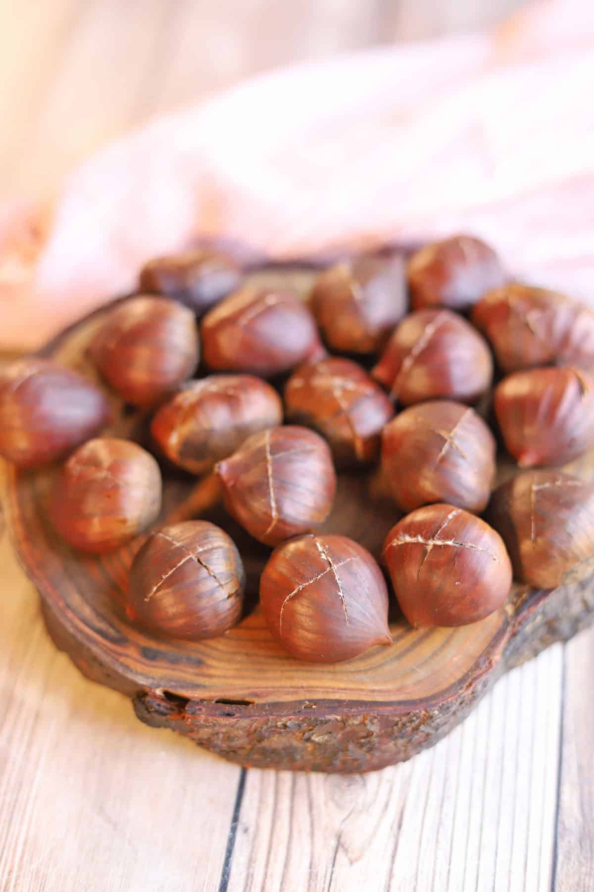 Chestnuts scored with an X in the shell.