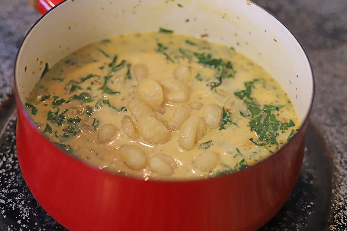 Gnocchi in creamy soup pot.