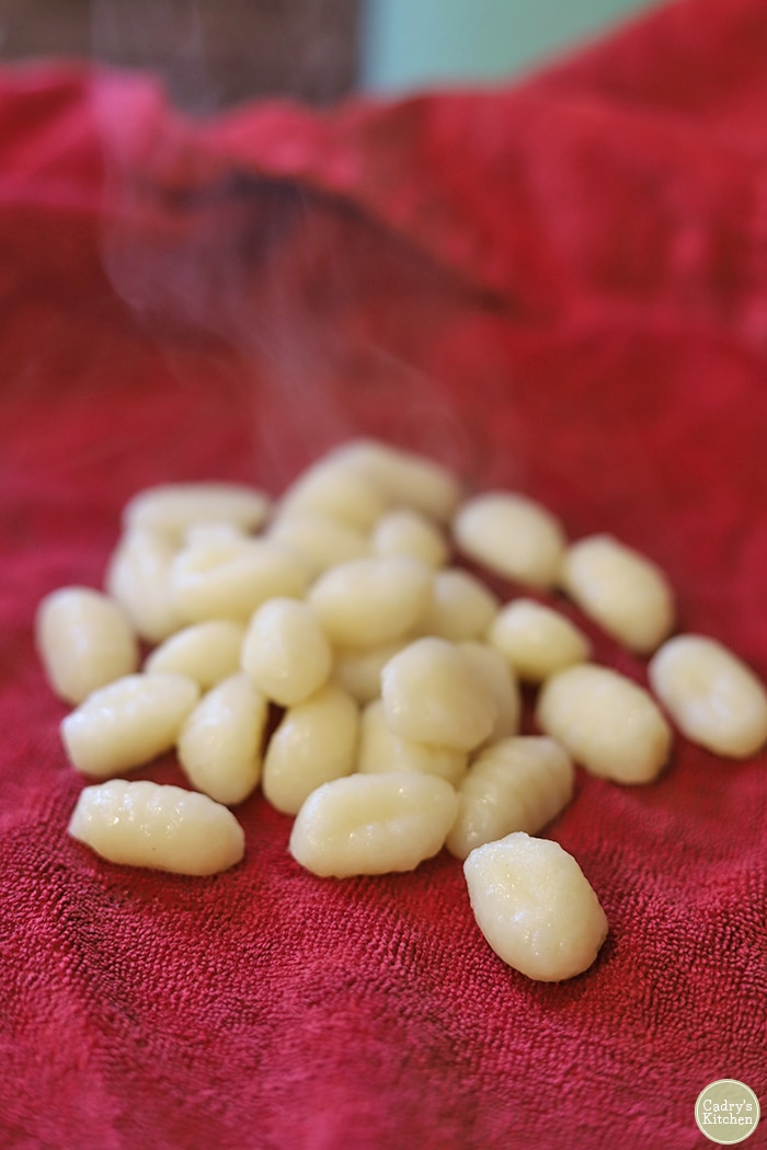 Drained gnocchi drying on a clean towel.