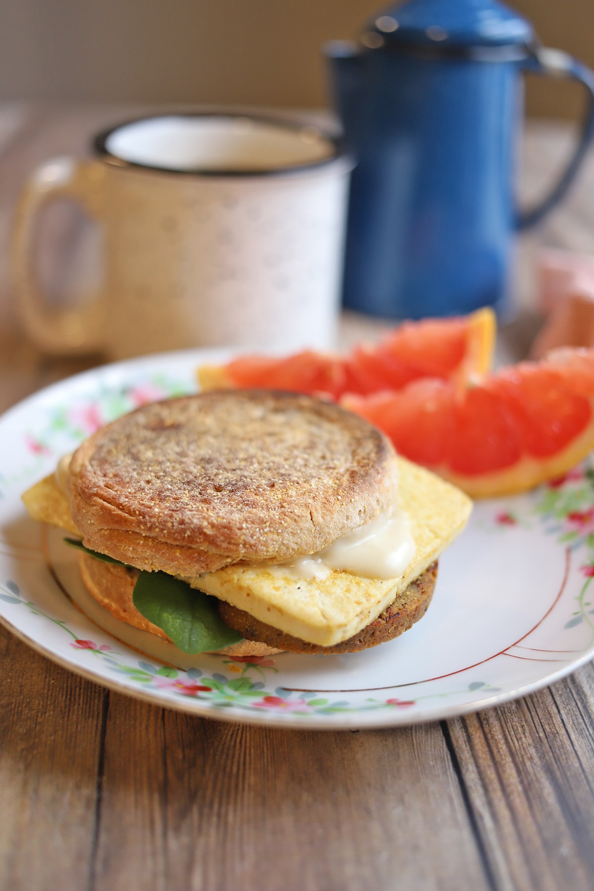 Close-up breakfast sandwich with eggy tofu and white cheddar sauce.