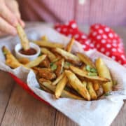 Oven baked fries in basket with ketchup dipping sauce.