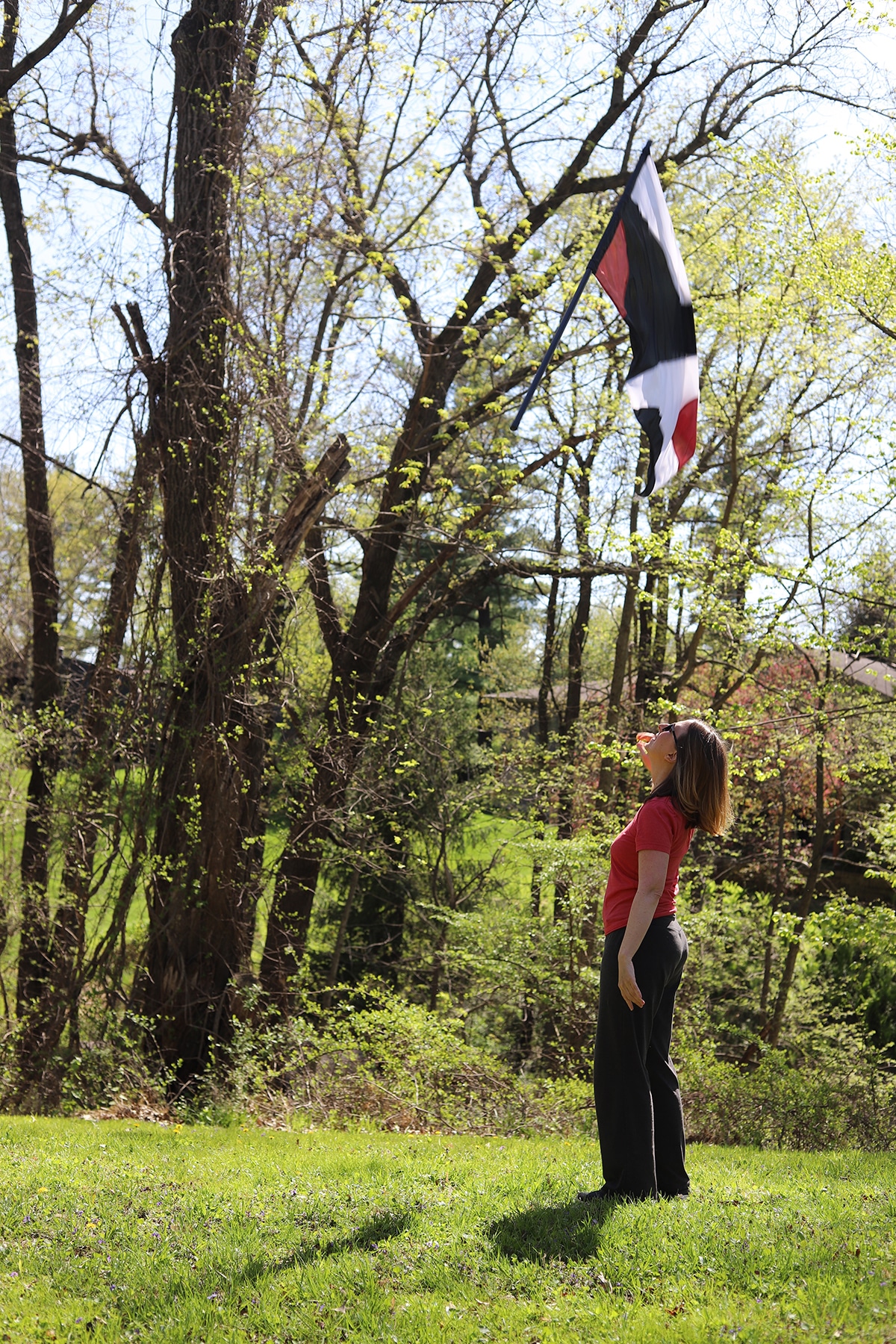 Cadry tossing Color Guard flag in yard.