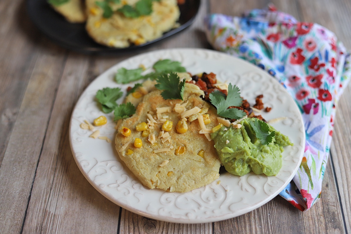 Corn cakes with soyrizo, guacamole, and cilantro.