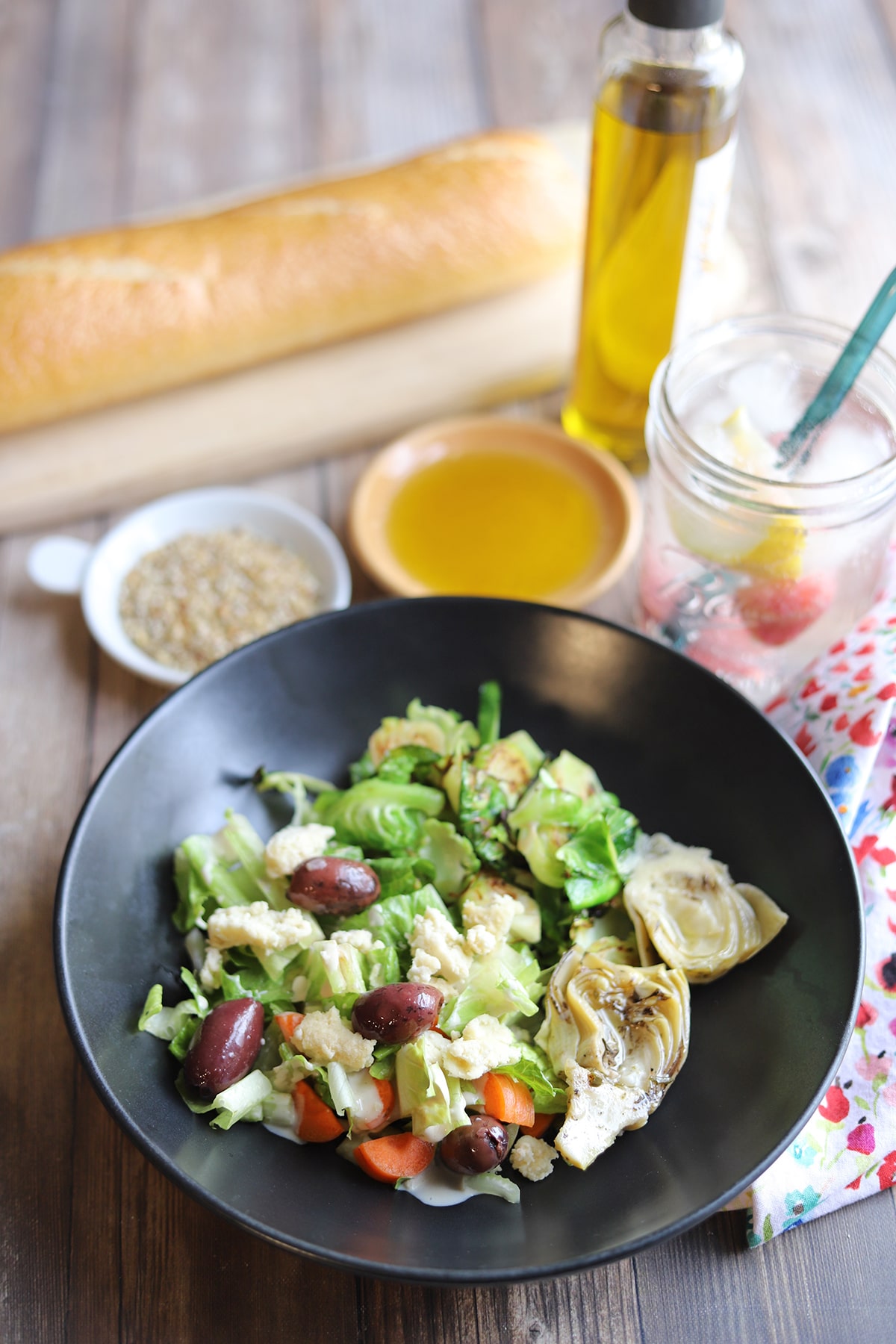 Spinach salad with artichoke hearts, non-dairy feta, and Brussels sprouts.