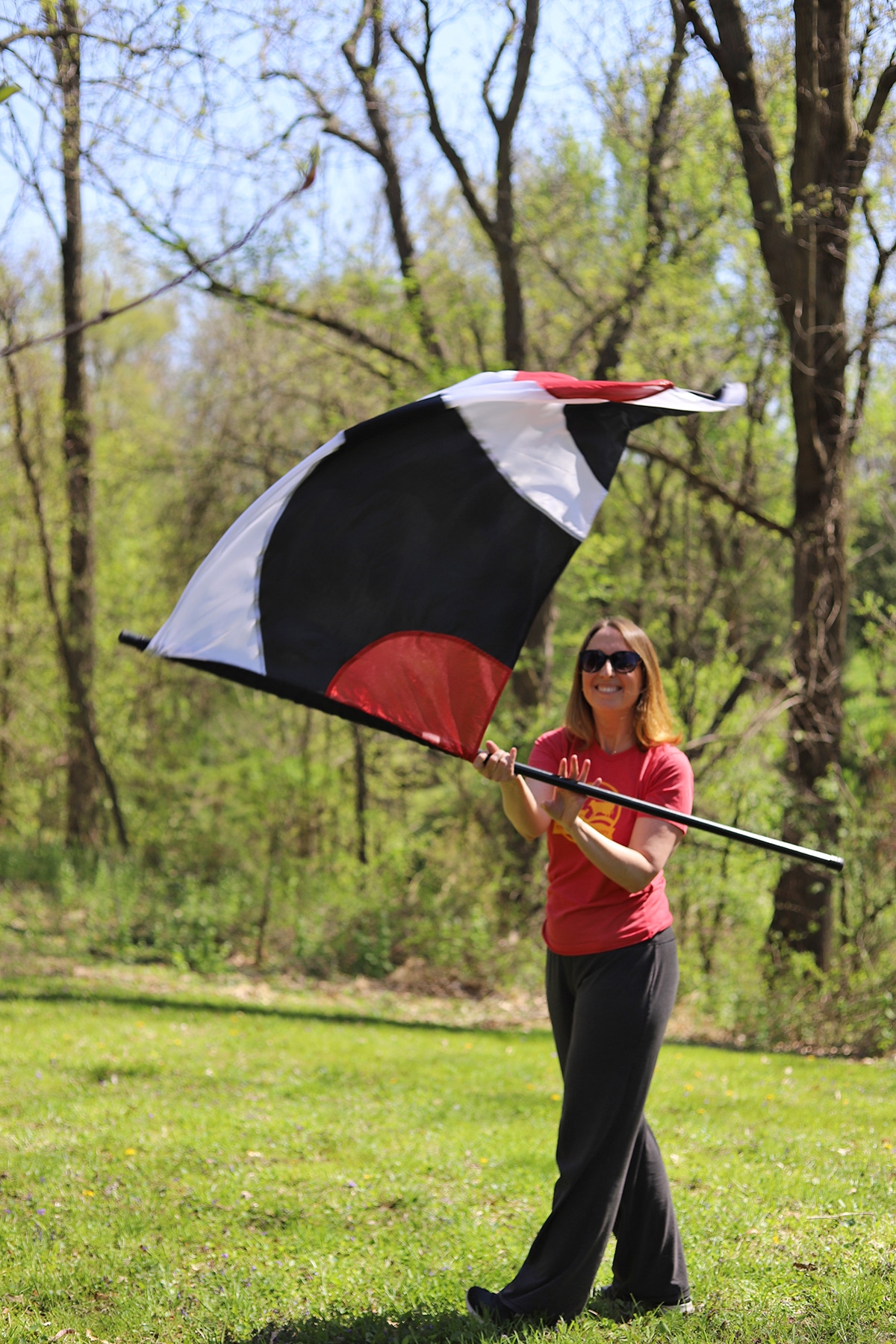 Cadry twirling a flag in the yard.