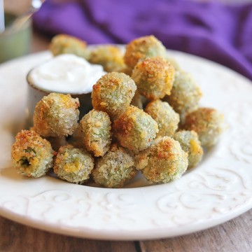 Fried olives on plate with aioli dipping sauce.