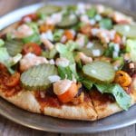 Whole pizza pie on metal tray.