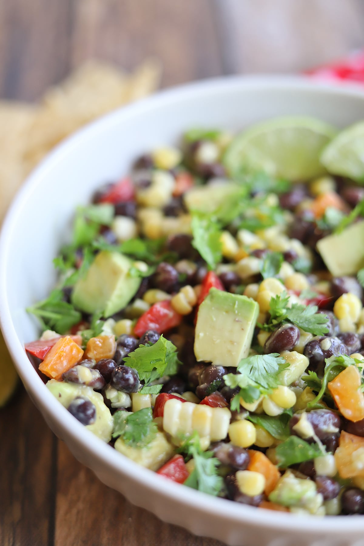 Close-up salad with corn, avocado, bell pepper, and black beans.