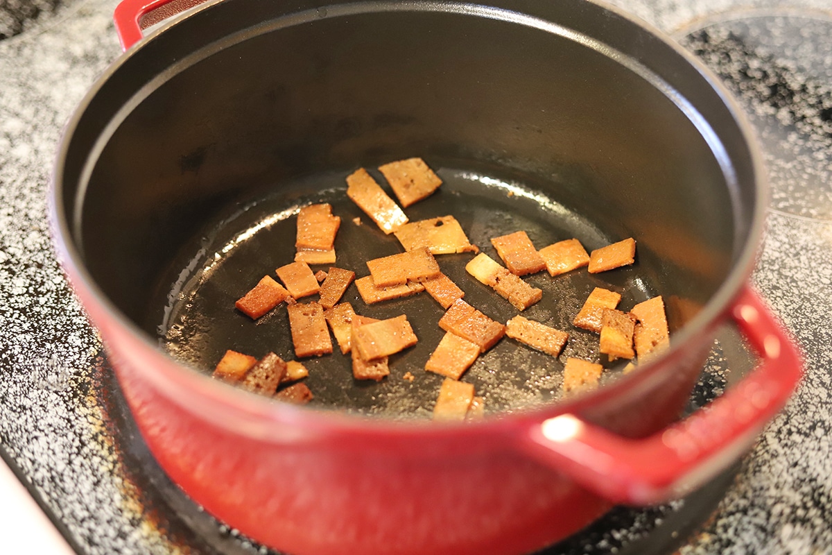 Seitan bacon browning in pot.