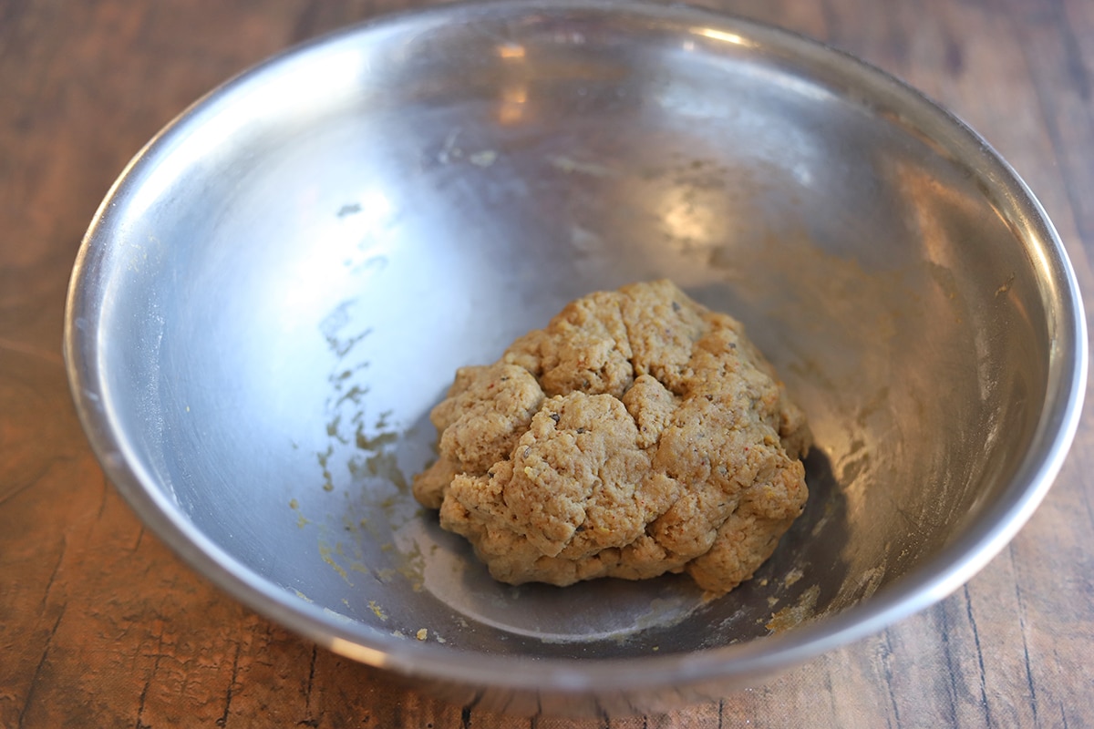 Wheat gluten formed into a ball in a mixing bowl.