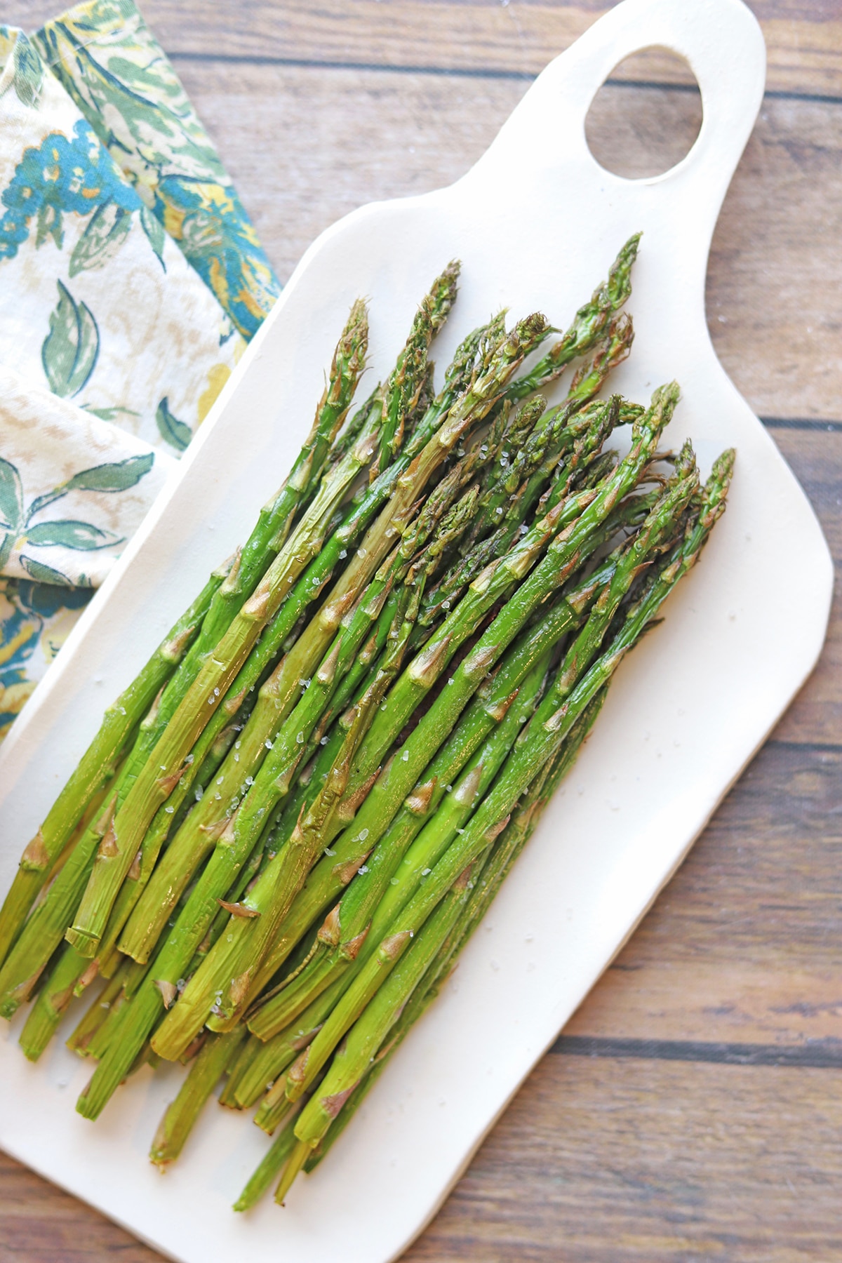 Pile of air fryer asparagus on platter.