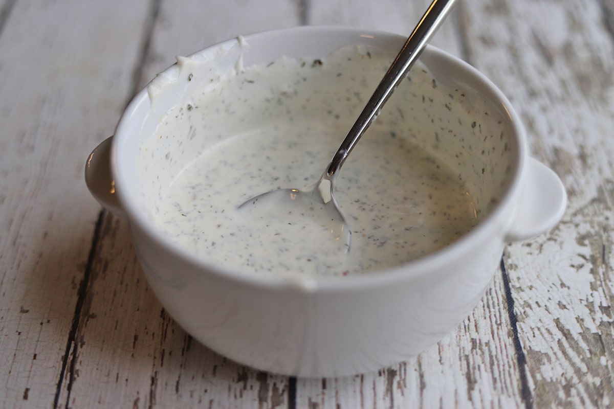 Mayo dressing in bowl with spoon.