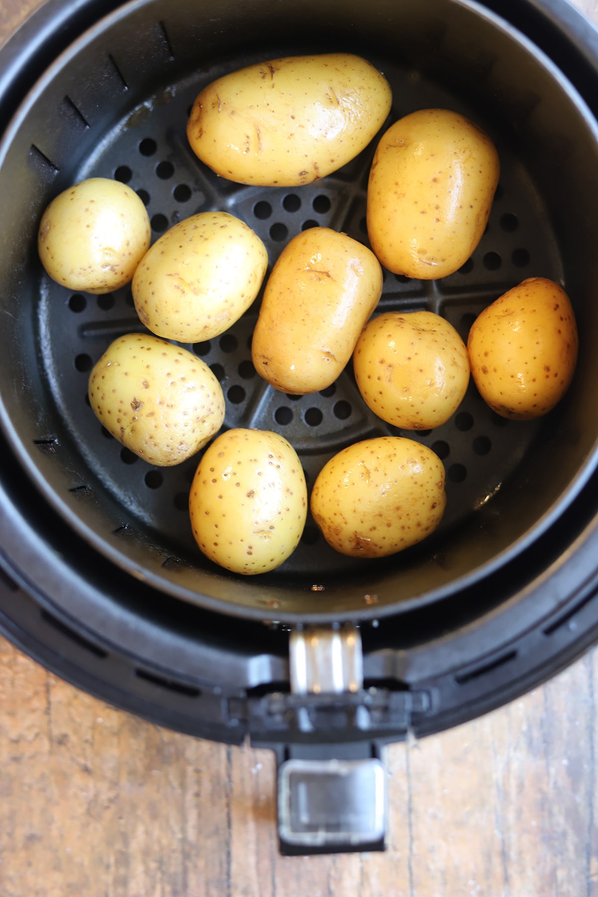 Baby potatoes in air fryer basket.