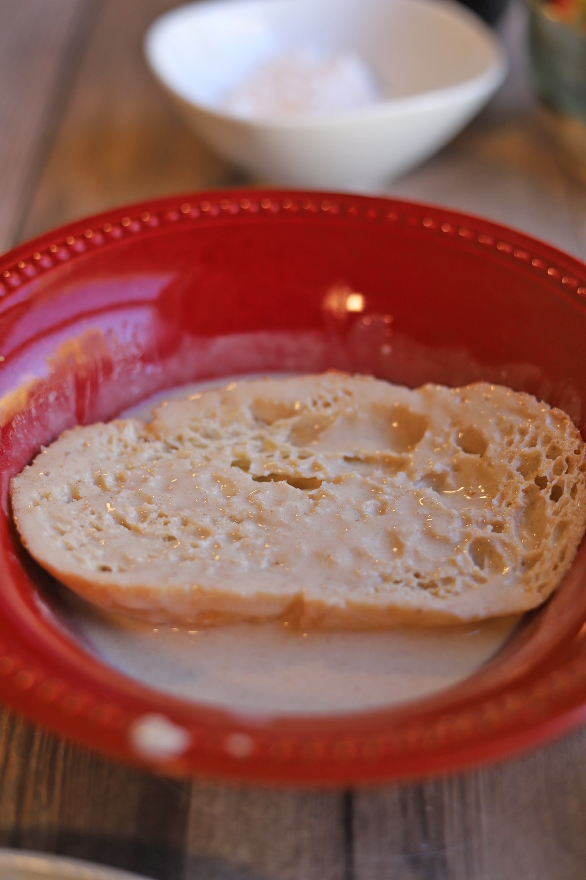 Sliced bread soaking in vegan eggnog.