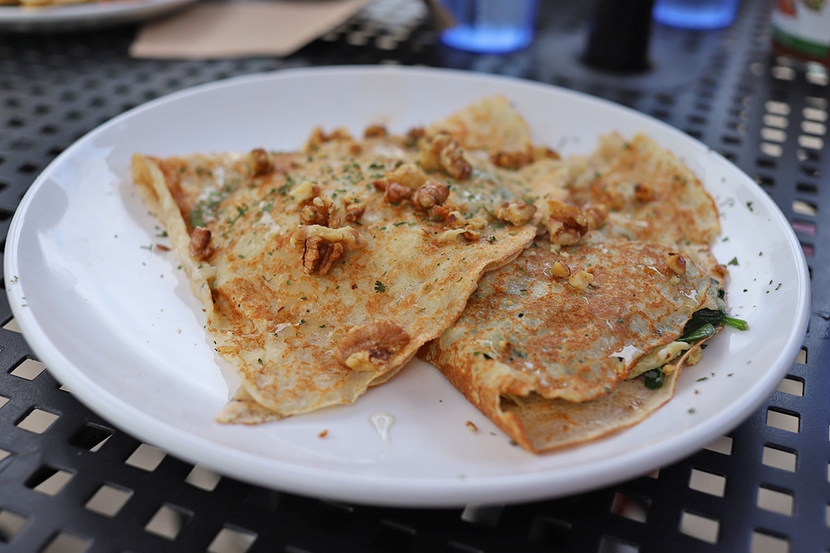 Vegan crepes topped with walnuts.