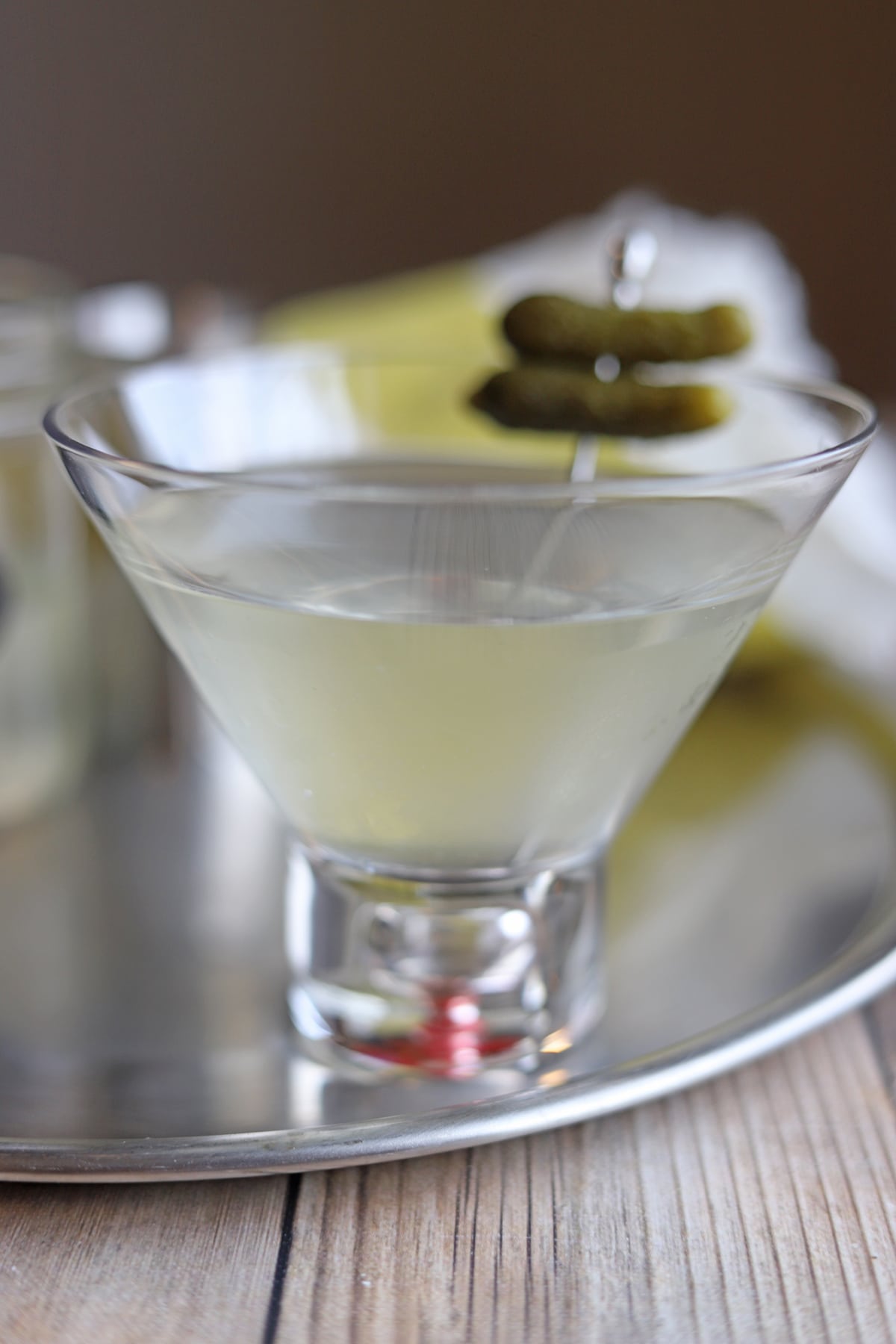 Pickle martini on tray.