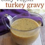 Text overlay: Easy vegan turkey gravy. Gravy boat on table by napkin.