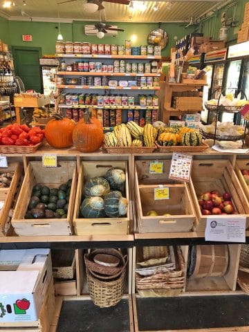 Interior grocery store with squash on display.