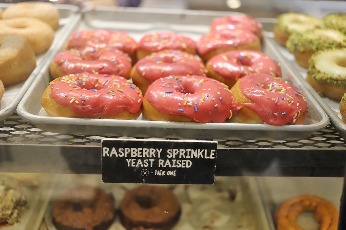 Raspberry frosted doughnuts on display.
