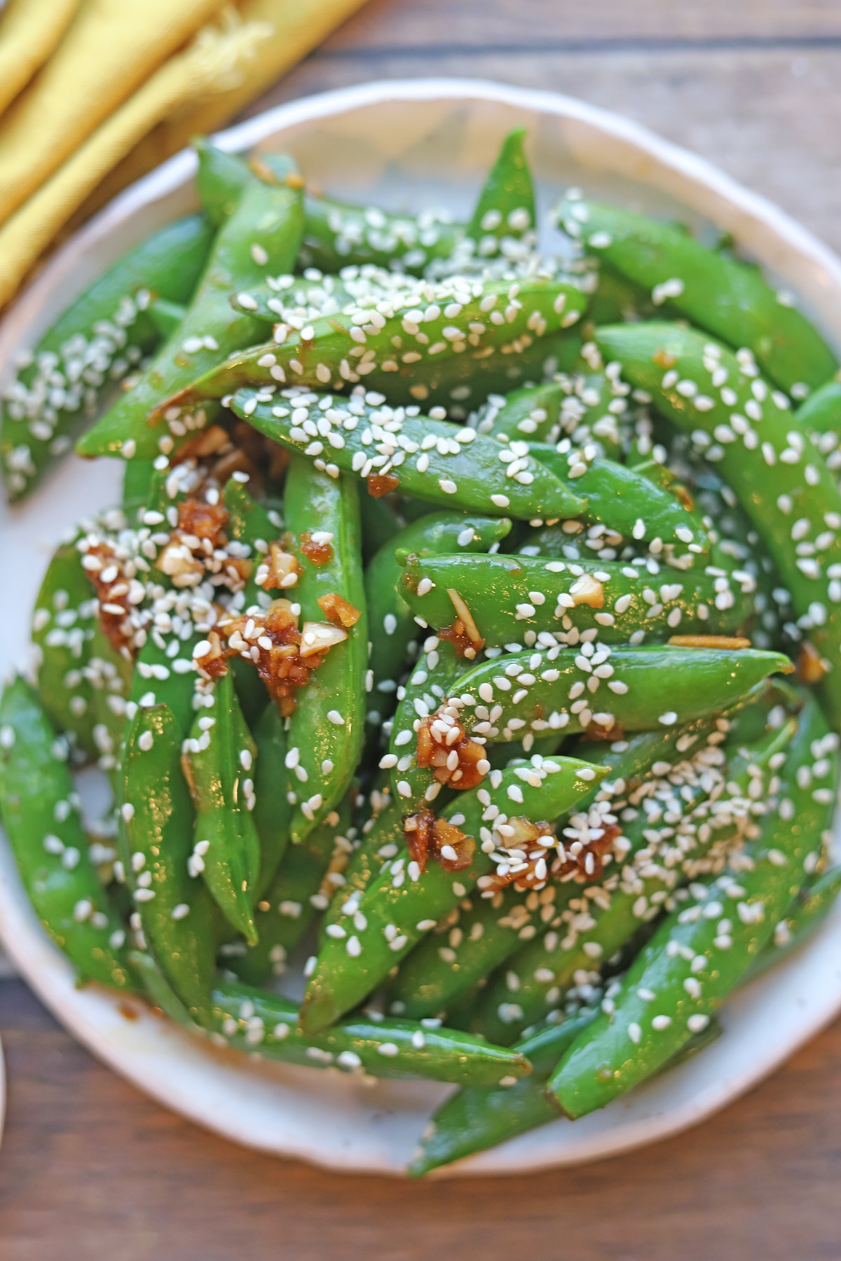 Overhead sugar snap peas stir fry with garlic and ginger.
