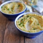 Two blue bowls of grits.