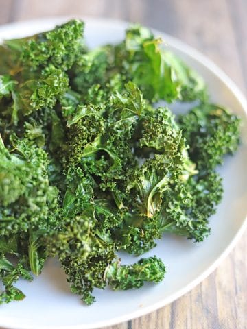 Kale chips on white plate.