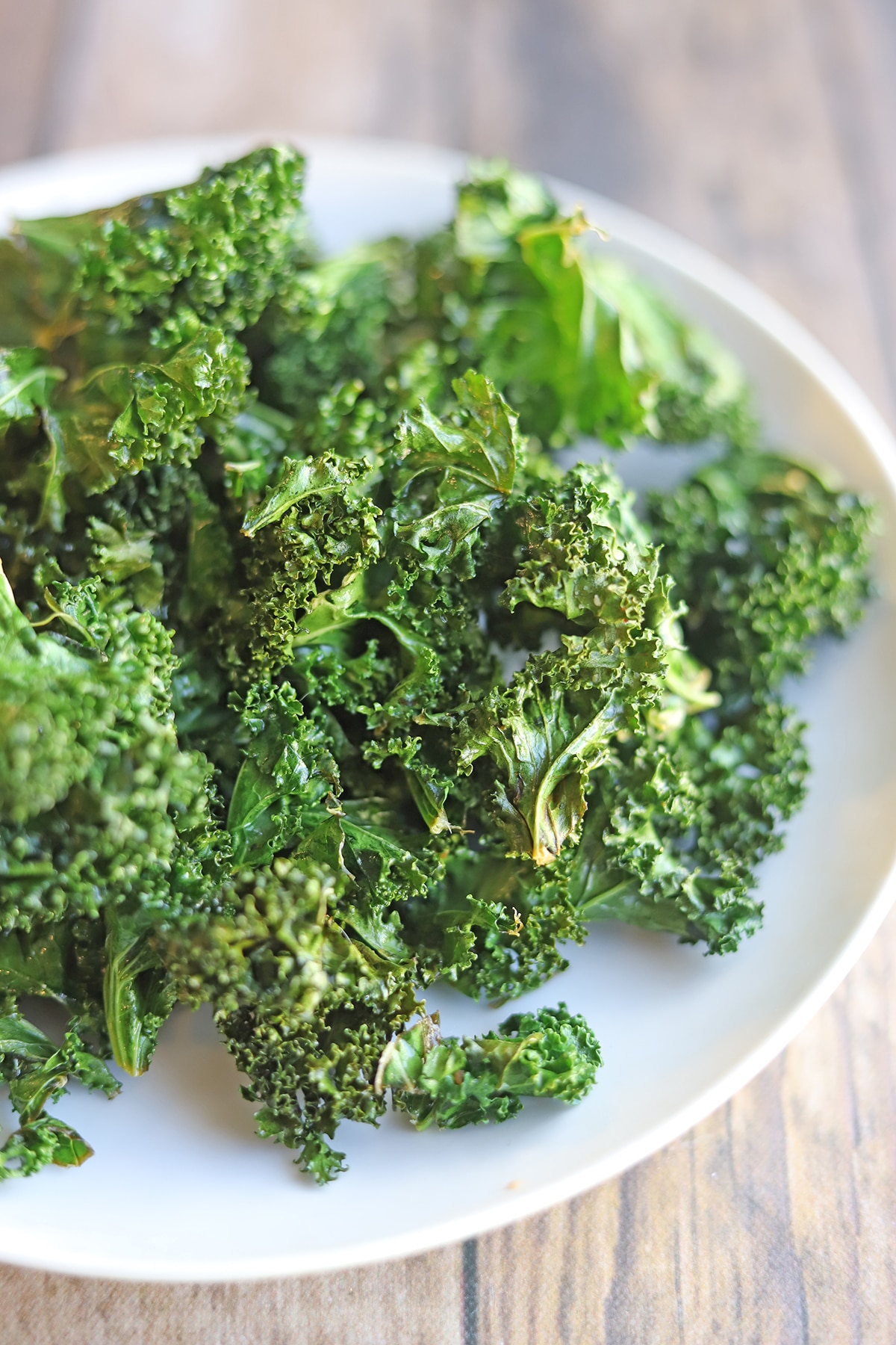 Kale chips on white plate.